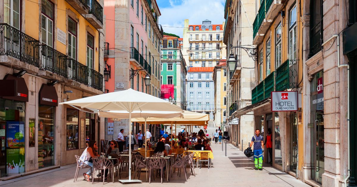 Calle con Restaurantes y Turistas en Lisboa