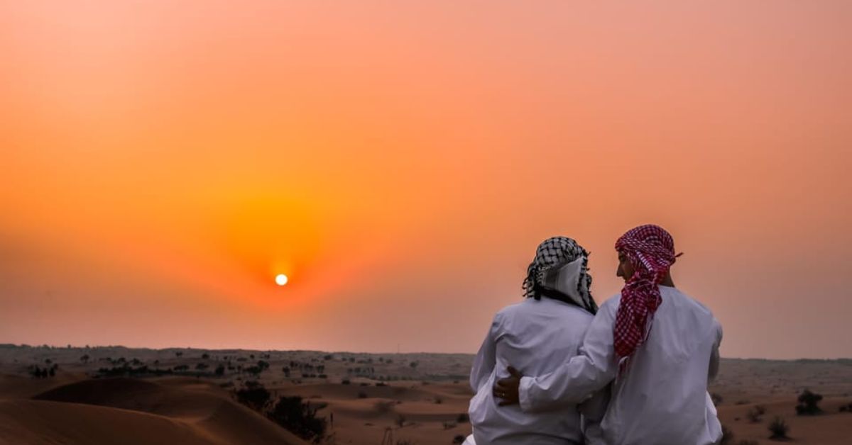 Pareja disfruta de atardecer en desierto de Dubái